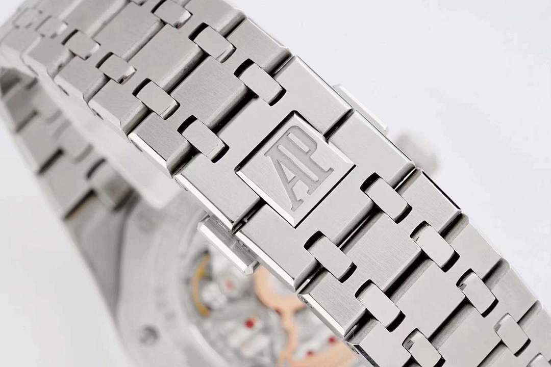 Metal watch bracelet clasp with raised logo plate and polished link edges