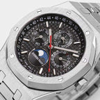 Royal Oak watch dial close-up with black face, red seconds hand, and multiple subdials