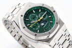 Stainless steel watch face close-up with green dial and multiple subdials