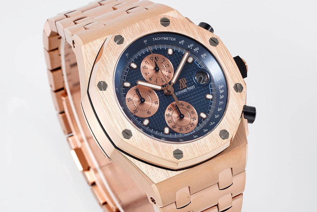 Rose-gold chronograph watch face angled view with blue dial and tachymeter bezel.