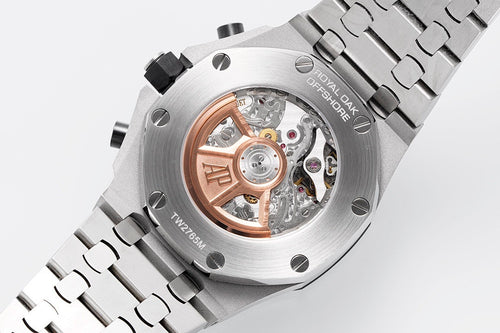 Audemars Piguet watch caseback with visible movement and steel bracelet.