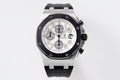 Audemars Piguet watch with silver dial, black chronograph subdials, black rubber strap