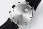 Audemars Piguet watch case back with engraved text and black rubber strap