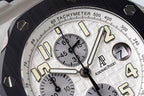 Audemars Piguet watch dial close-up with tachymeter scale and gold-tone indices
