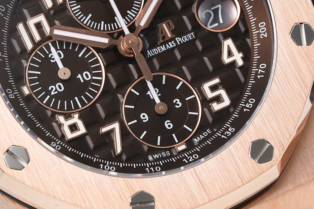 Audemars Piguet watch with black dial, rose-gold accents, and tachymeter-style markings