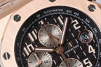 Black tachymeter dial close-up with rose markers, subdials, and bold numerals