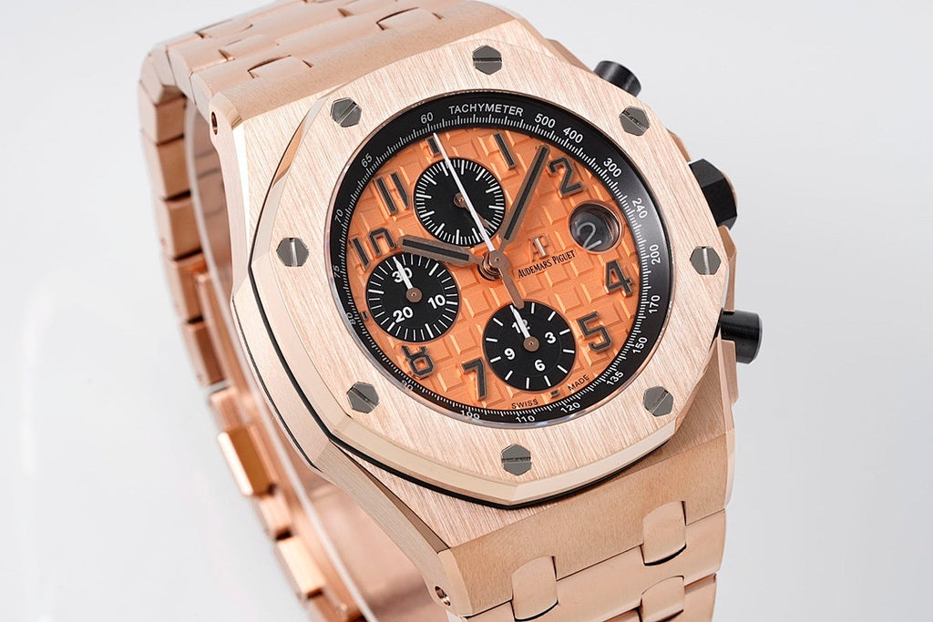 Audemars Piguet watch, angled view of rose-gold case, orange dial, and tachymeter bezel