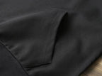 Black fabric close-up showing side seam stitching on the garment