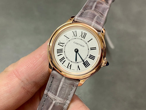 Cartier round wristwatch, silver Roman dial, gray leather strap, gold-tone case