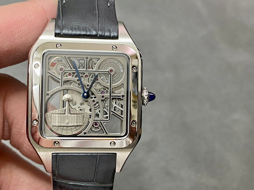 Square skeleton watch with silver-tone case and black leather strap, blue-tipped crown