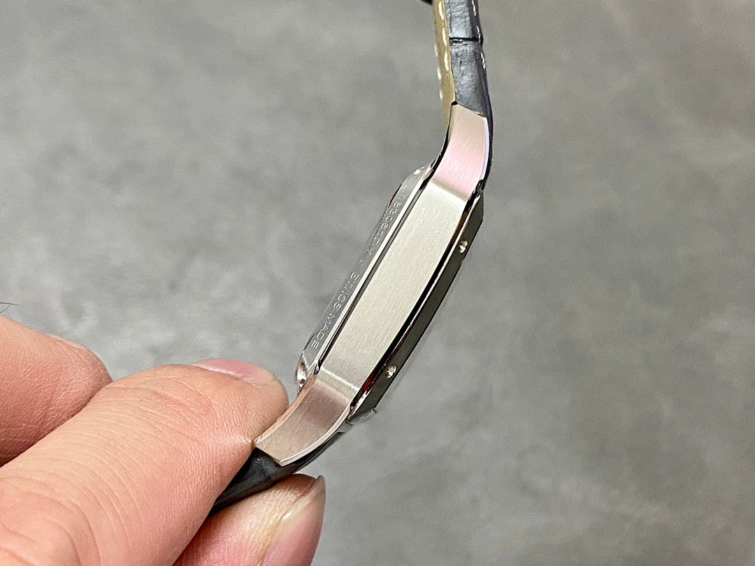 Side profile of a square watch case on a black leather strap