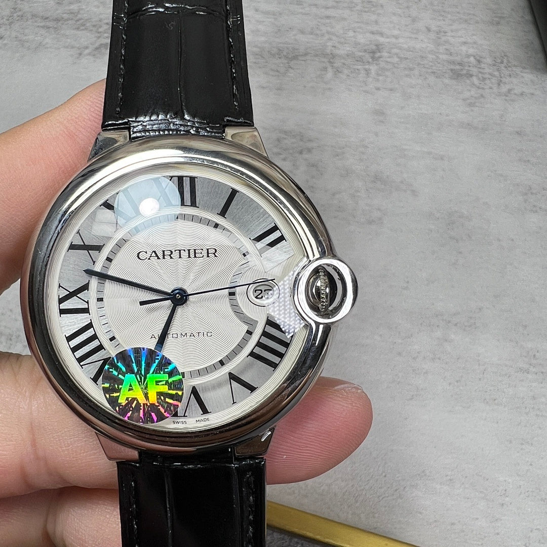 Round wristwatch with silver case, black leather strap; white dial and crown at 3 o'clock.
