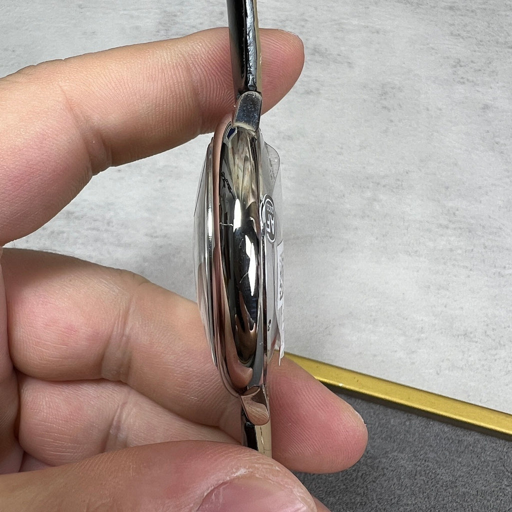 Silver-tone watch case side with polished bezel and black leather strap; thin profile.