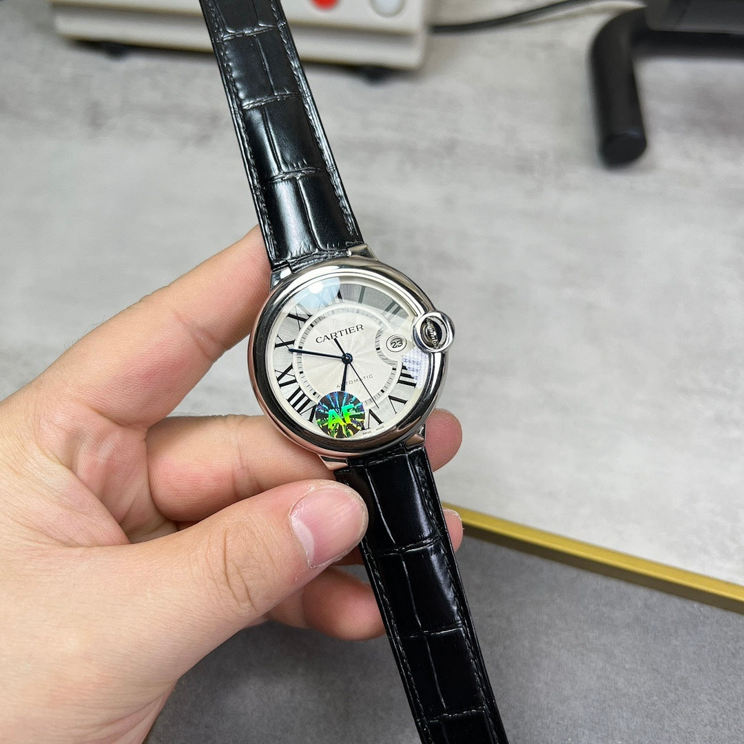 Round wristwatch with black leather strap; white dial with black hands and subdial detail.