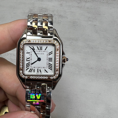 Cartier watch front view with rectangular white dial, Roman numerals, diamond-set bezel, bracelet