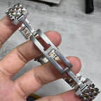Cartier watch clasp side view with metal links and engraved hardware