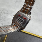 Cartier watch case back with text and metal bracelet