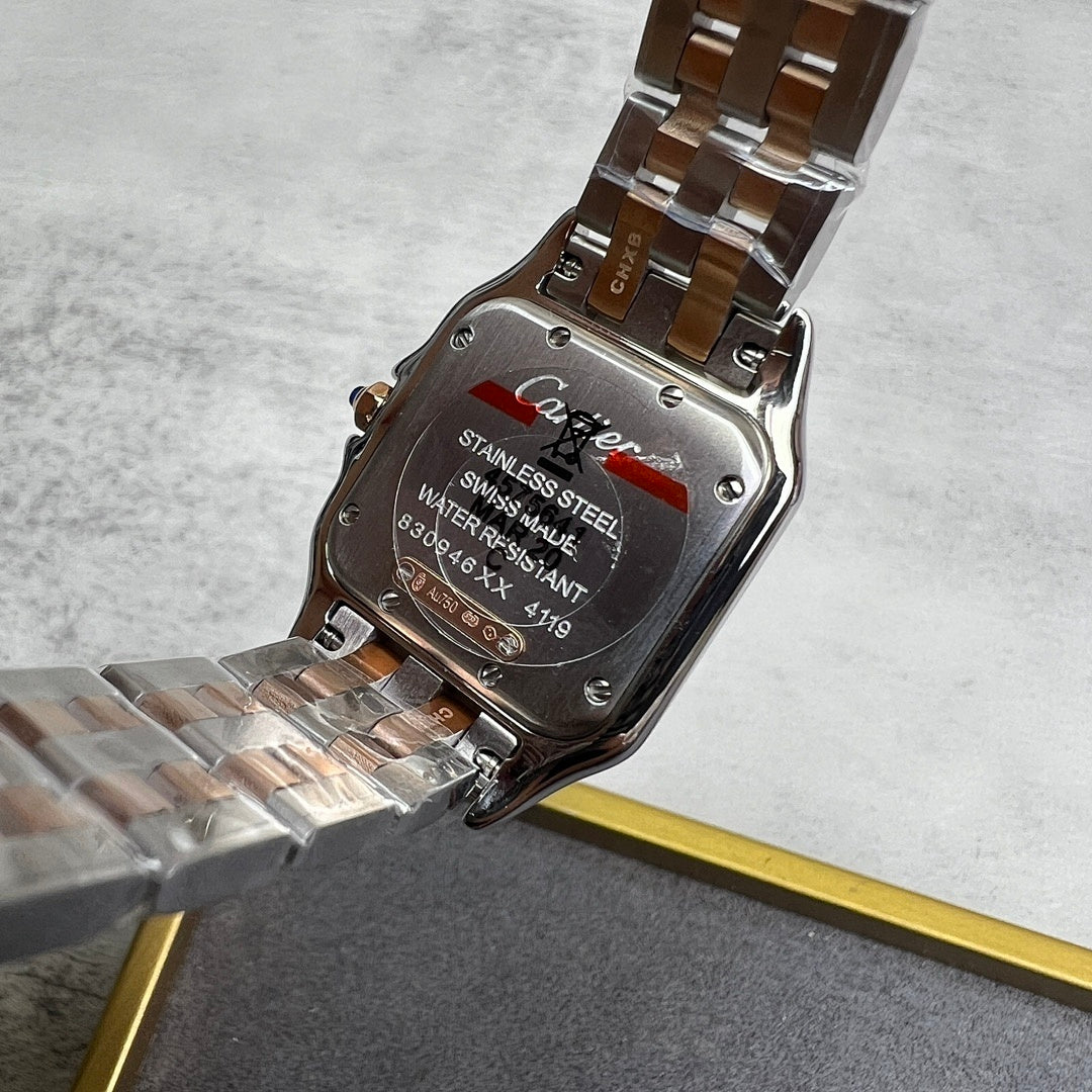 Cartier watch case back with text and metal bracelet