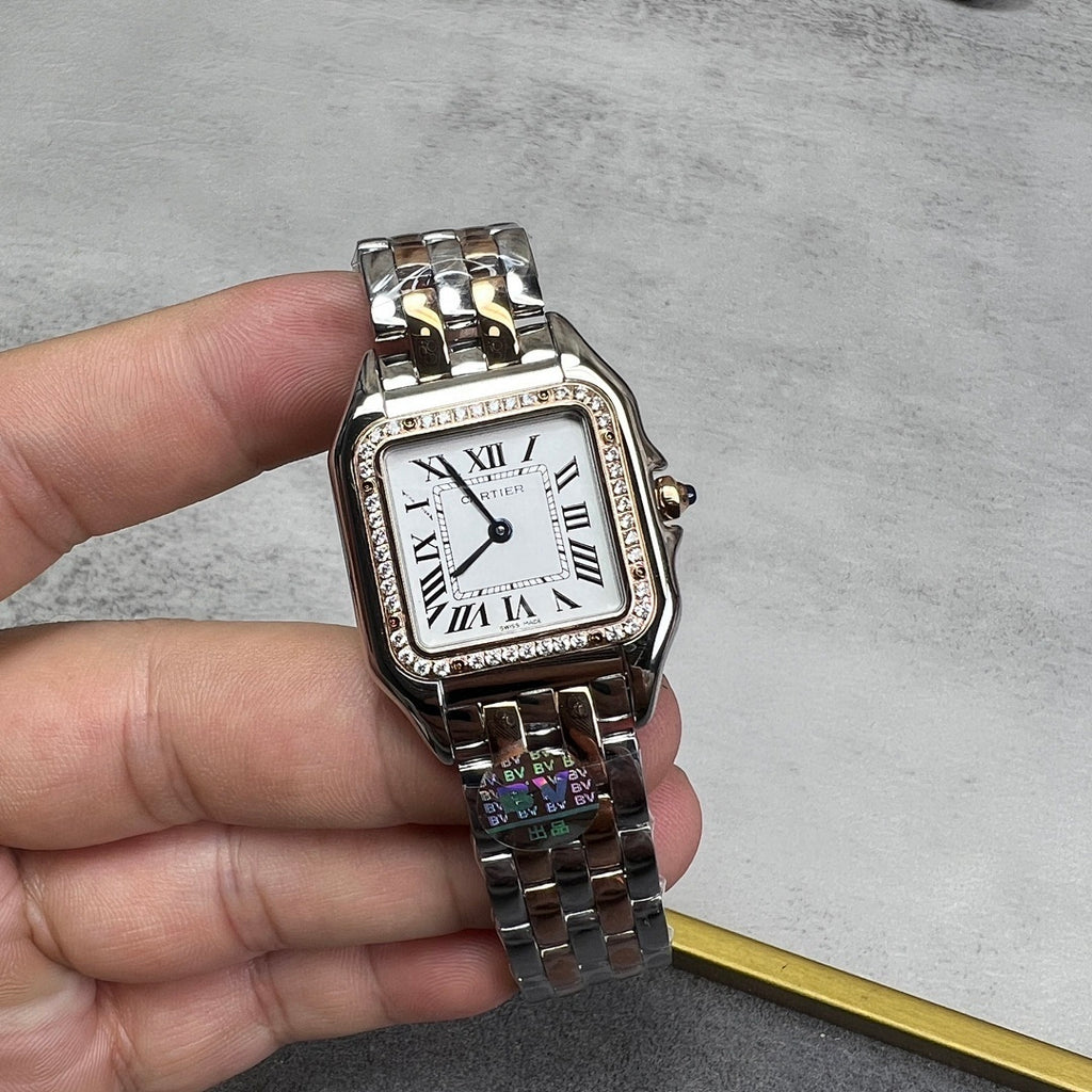 Cartier watch with rectangular white dial, Roman numerals, diamond bezel, metal bracelet