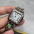 Cartier watch with rectangular silver dial, Roman numerals, diamond bezel, metal bracelet