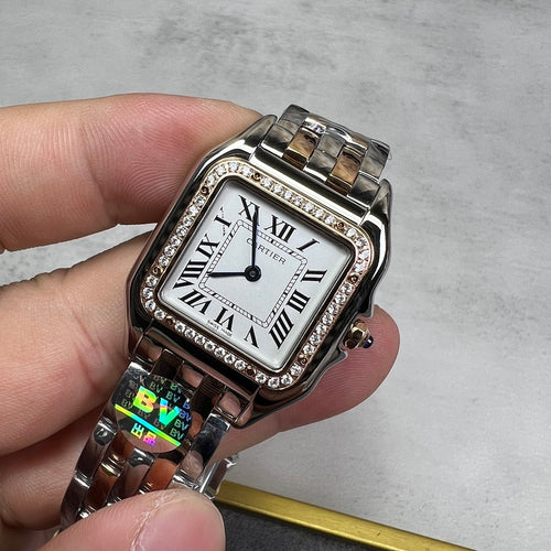 Cartier watch with rectangular silver dial, Roman numerals, diamond bezel, metal bracelet