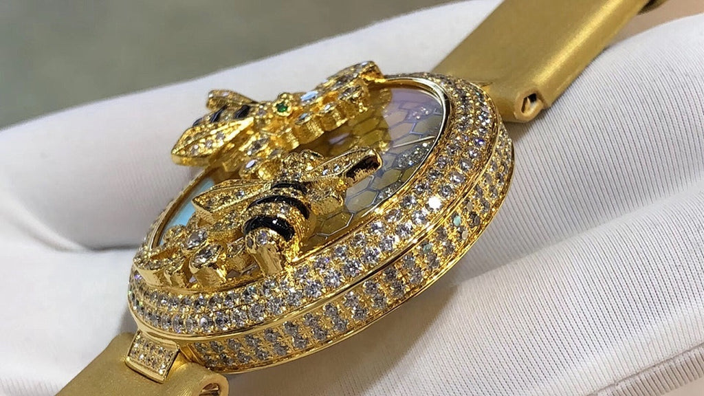 Cartier watch with gold-tone strap and jeweled round bezel, honeycomb dial and cat ornament