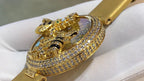 Cartier watch with gold-tone strap and jeweled round bezel, honeycomb dial and cat ornament