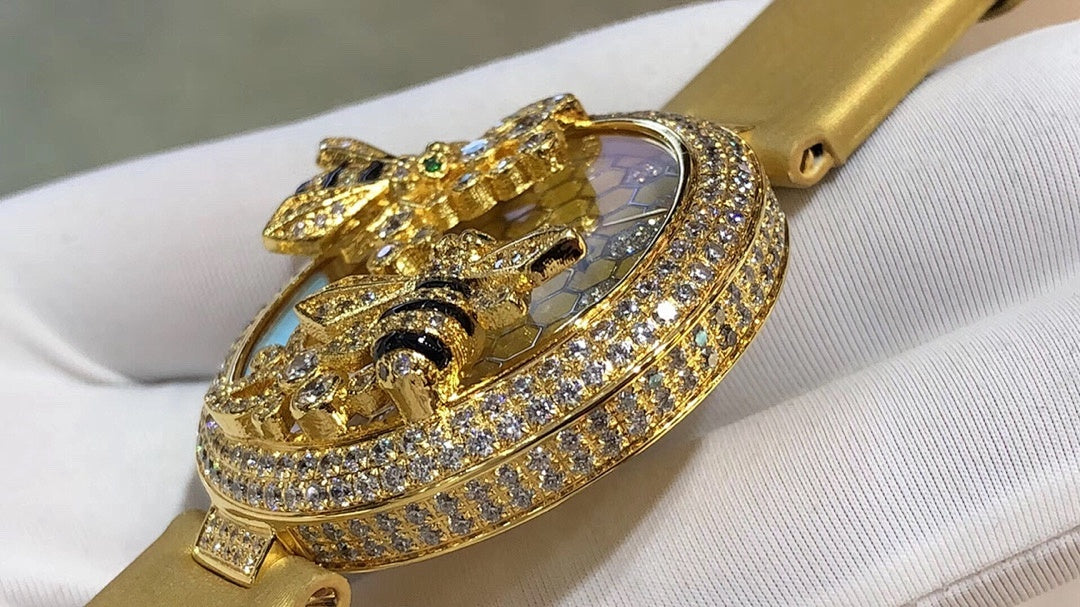 Cartier watch with gold-tone strap and jeweled round bezel, honeycomb dial and cat ornament