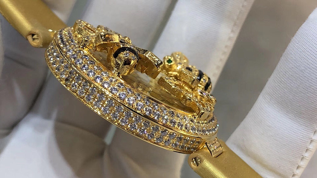 Cartier watch angled view showing gold-tone case, diamond-studded bezel and side crown