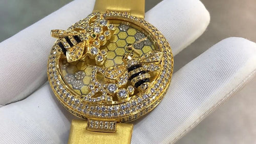 Cartier watch with gold-tone strap, round gem bezel, honeycomb dial and jeweled cat motif