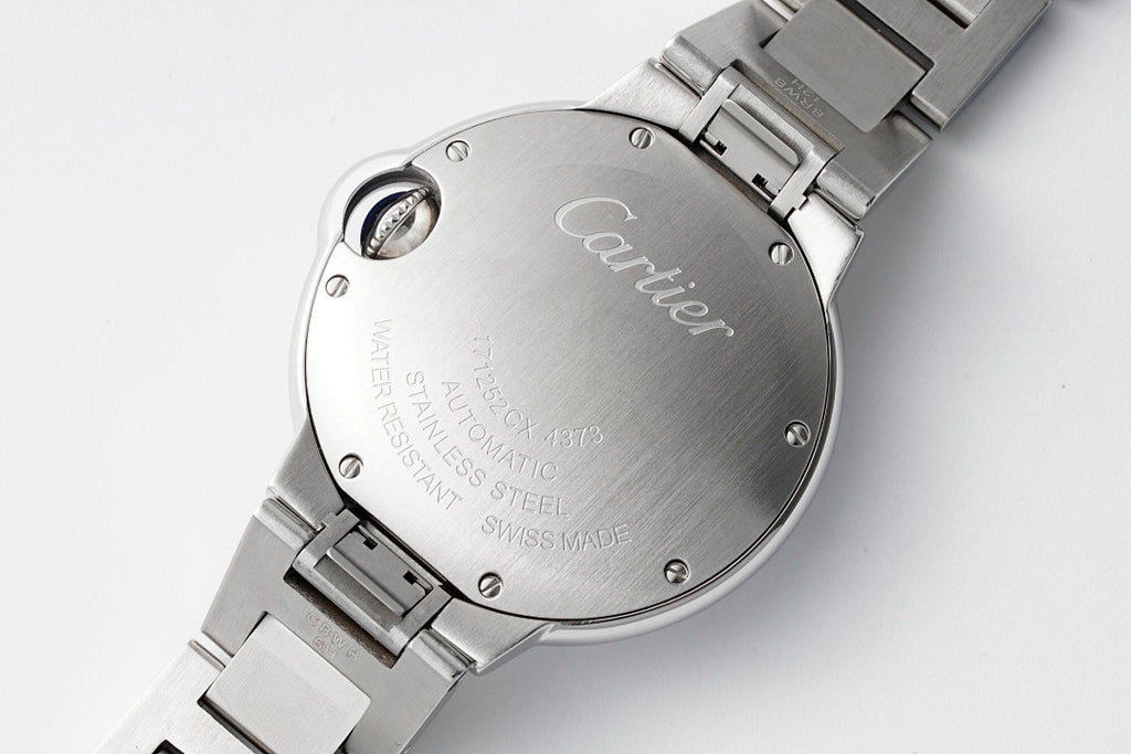 Cartier stainless steel watch case back with crown and engraved text