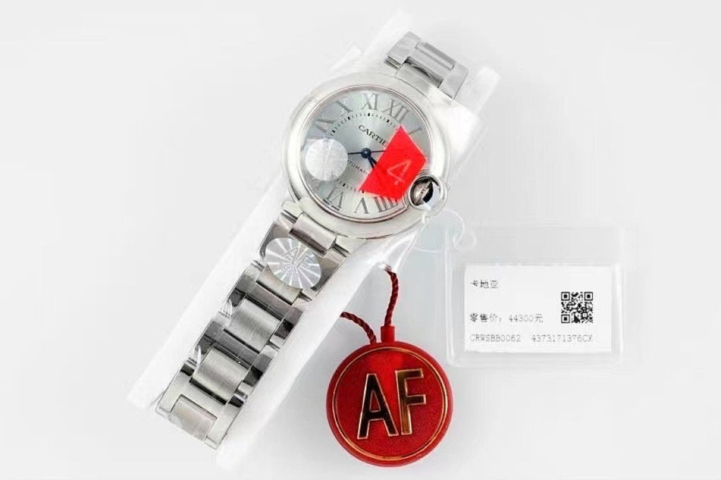 Cartier watch with silver dial, steel bracelet, and red AF charm with tag card