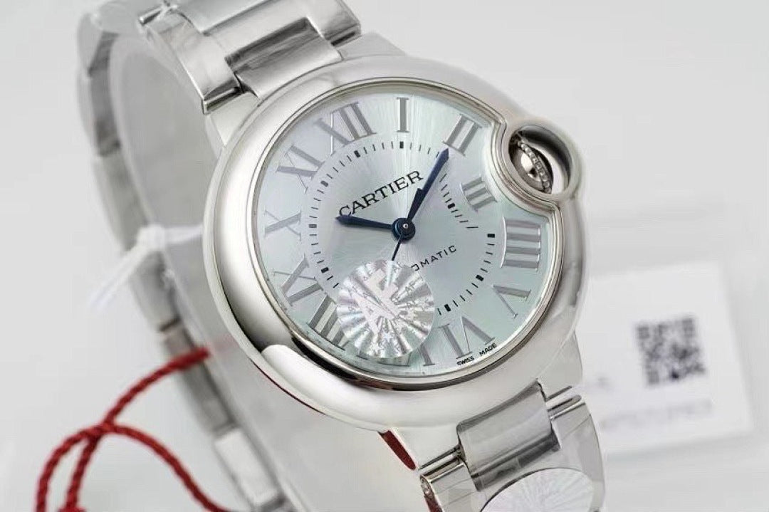 Cartier watch close-up of silver dial with Roman numerals and steel bracelet