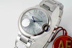 Cartier watch dial close-up with steel bracelet and red AF charm