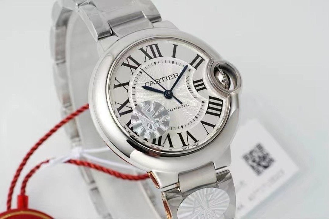 Cartier watch close-up on white dial, silver case, Roman numerals, red cord