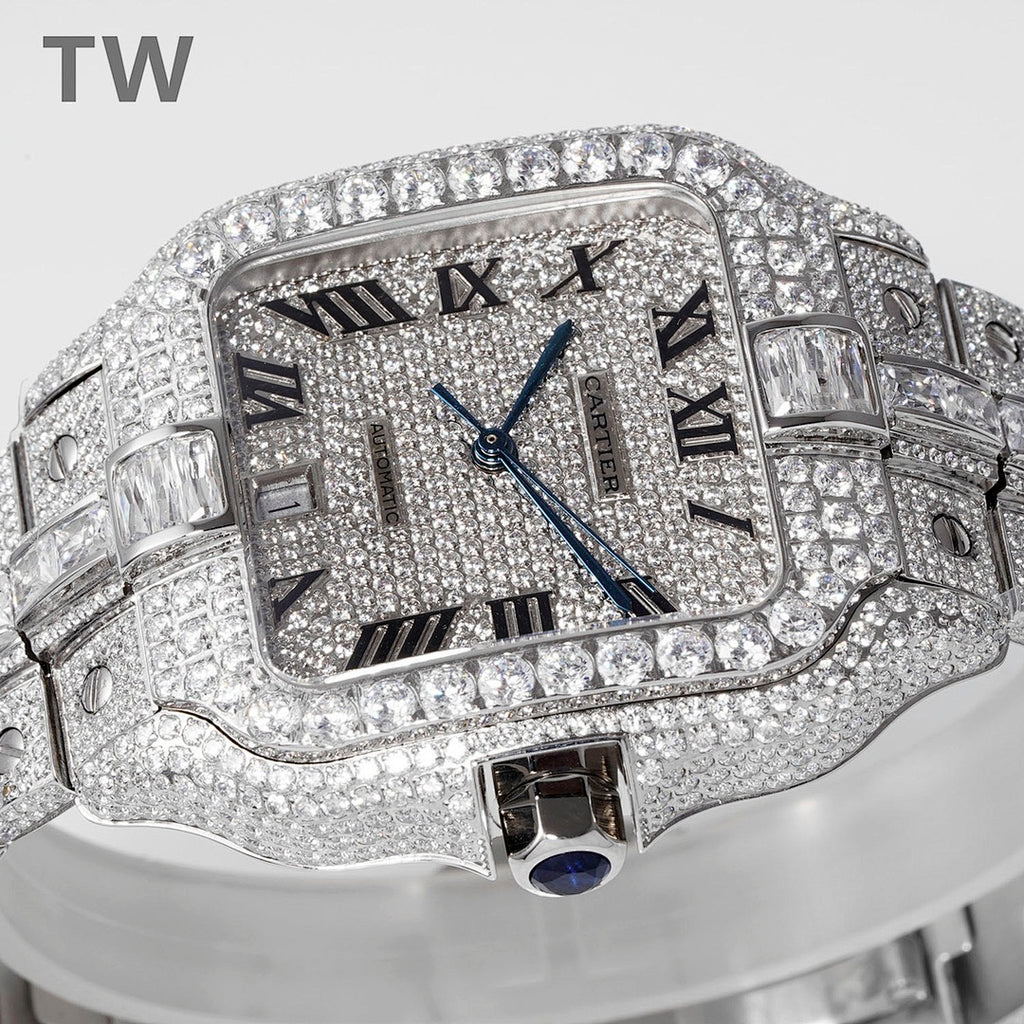 Diamond-studded rectangular wristwatch with Roman numerals, blue hands, and metal bracelet.