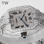Diamond-studded rectangular wristwatch with Roman numerals, blue hands, and metal bracelet.