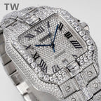 Diamond rectangular wristwatch with blue hands, Roman numerals, and metal link bracelet.