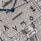 Cartier wristwatch dial close-up with blue "AUTOMATIC" text and diamond hour markers