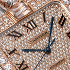 Cartier watch dial close-up, “Cartier” and blue seconds hand on diamond pavé