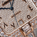Cartier diamond watch dial close-up with blue sword hands, gem indexes, rose-gold trim