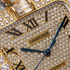 Cartier watch dial close-up with Cartier logo, diamond pavé, and Roman numerals.