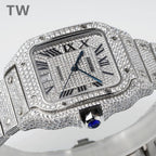 Diamond-set rectangular watch with Roman numerals, blue hands, and blue cabochon