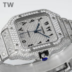 Diamond Cartier watch with black numerals, blue hands, and blue crown detail.