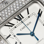 Close-up Cartier watch face with Roman numerals, blue hands, and date window