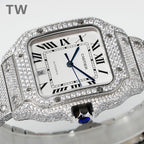 Diamond-encrusted Cartier watch with square dial, blue hands, and Roman numerals