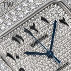 Close-up of Cartier watch face with blue hands and diamond dial