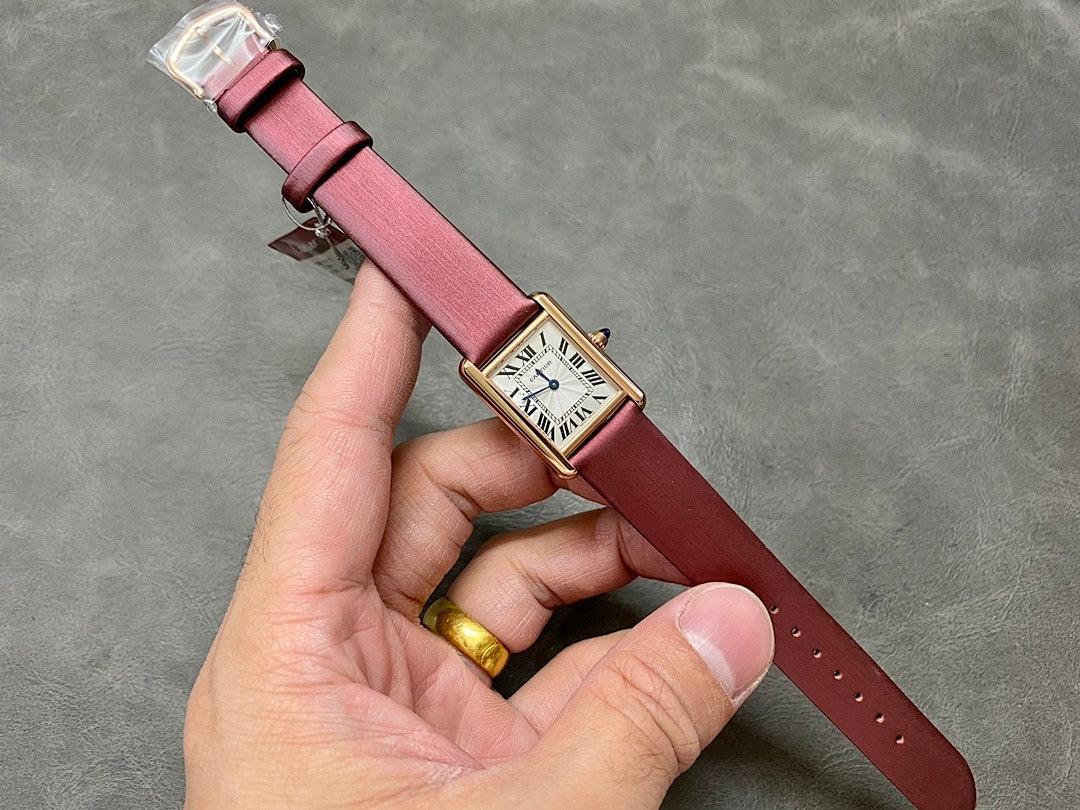 Rectangular wrist watch with burgundy leather strap, gold case, white Roman dial