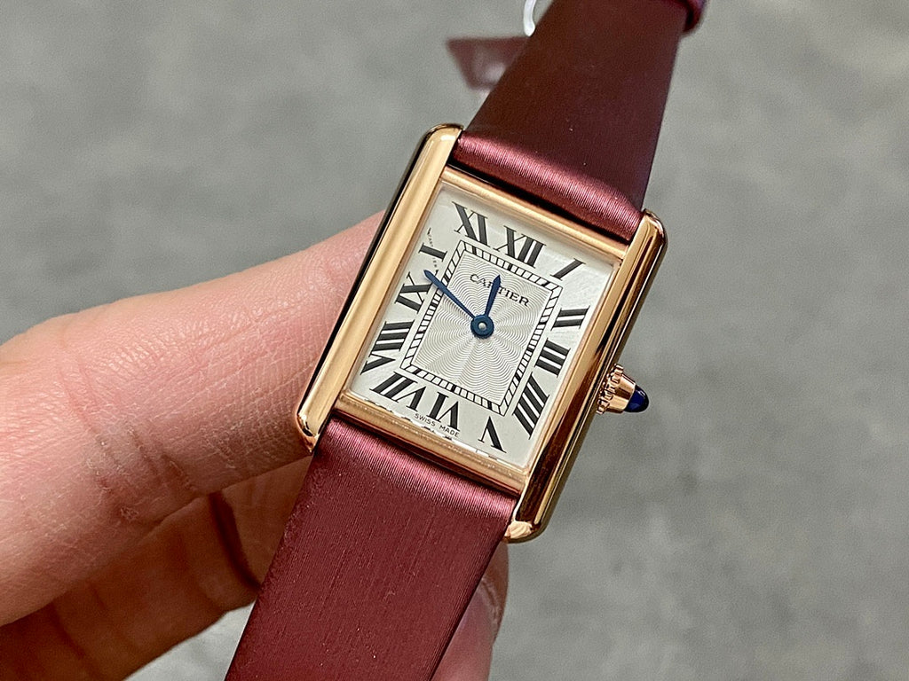 Cartier rectangular wrist watch with burgundy leather strap, gold case, white Roman dial