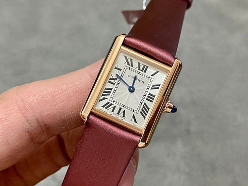 Cartier rectangular wrist watch with burgundy leather strap, gold case, white Roman dial
